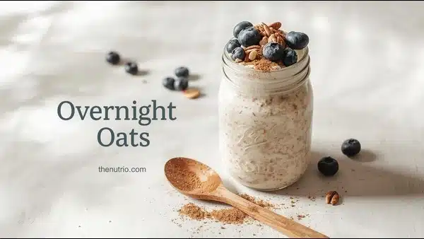 Mason jar of overnight oats topped with nuts and berries.